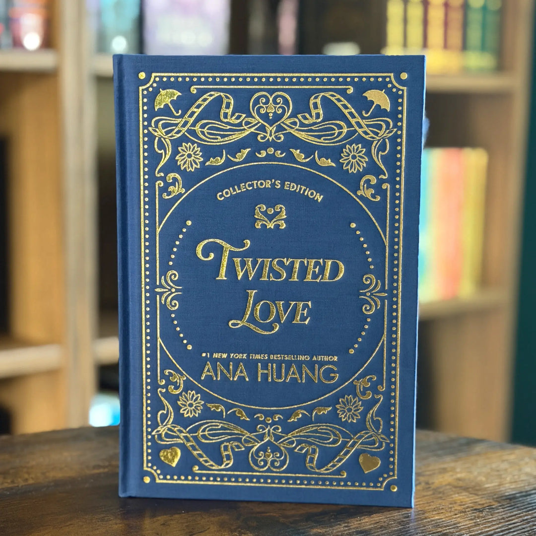 Blue book titled 'Twisted Love' by Ana Huang with gold text on a wooden surface.