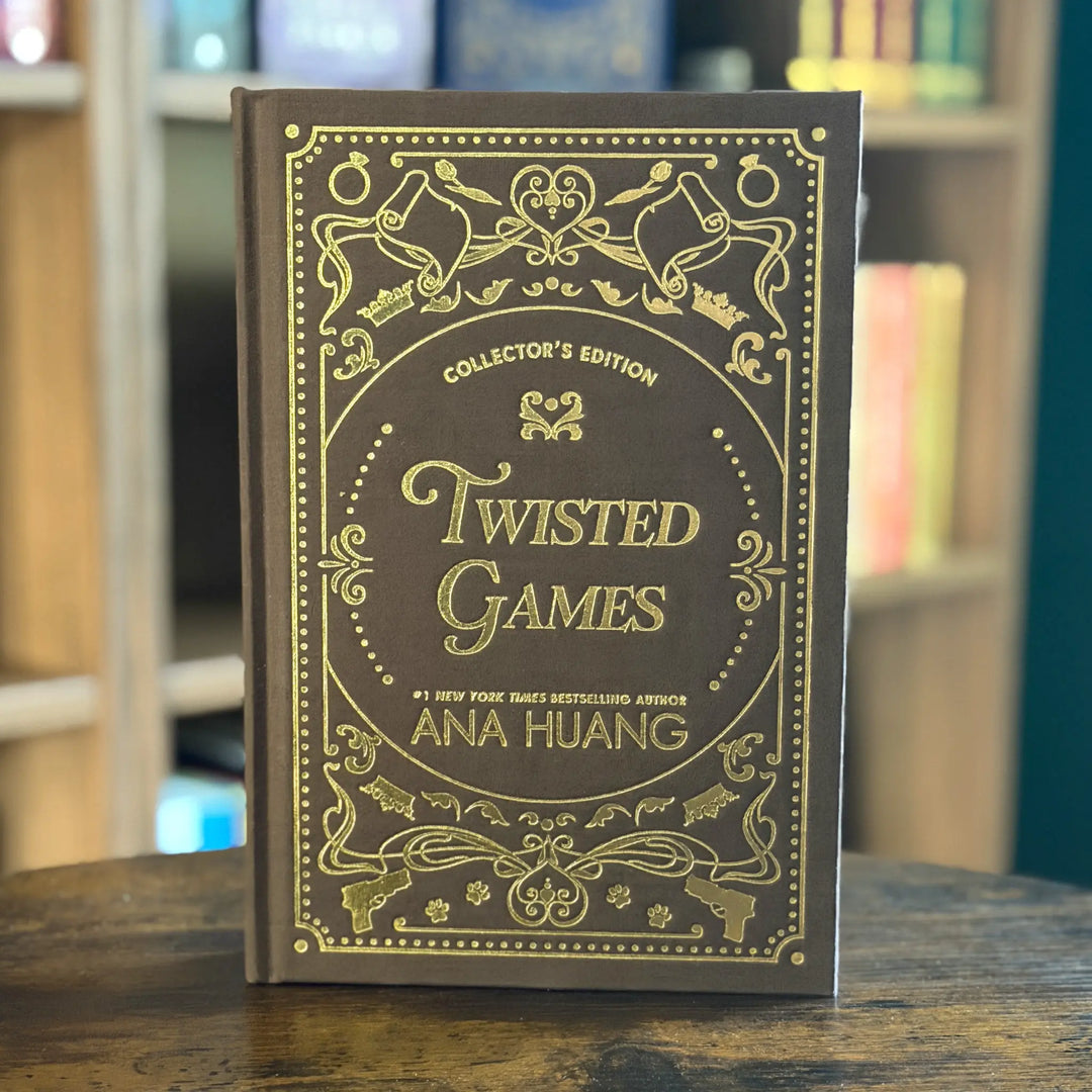 Book titled 'Twisted Games' by Ana Huang with decorative cover on a wooden surface.