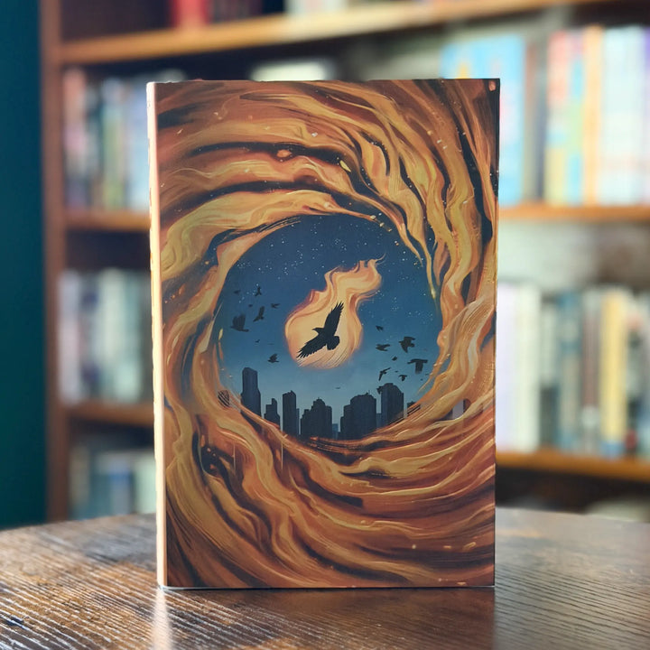 Book with a fiery design on a wooden surface with a blurred bookshelf background