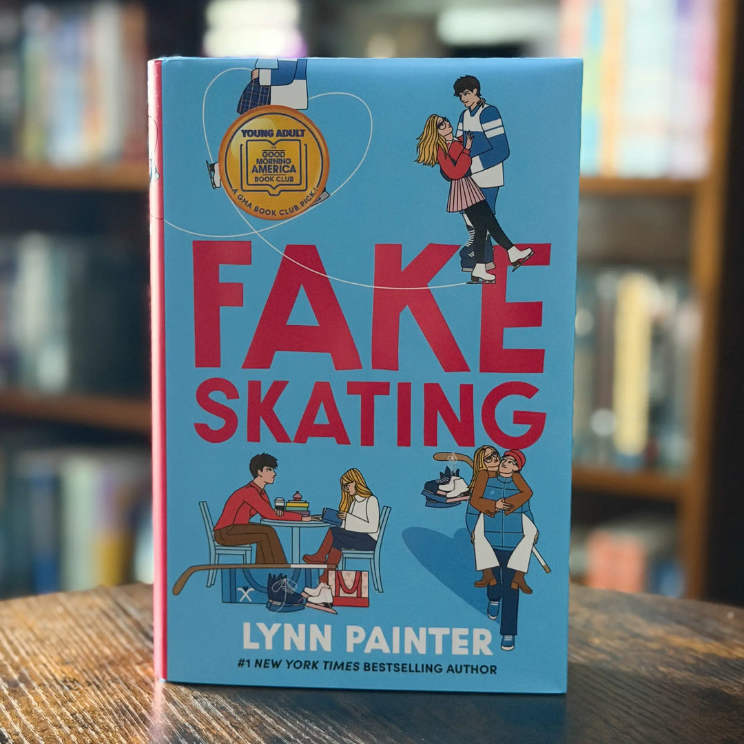 Book titled 'Fake Skating' by Lynn Painter on a wooden surface with a blurred bookshelf background
