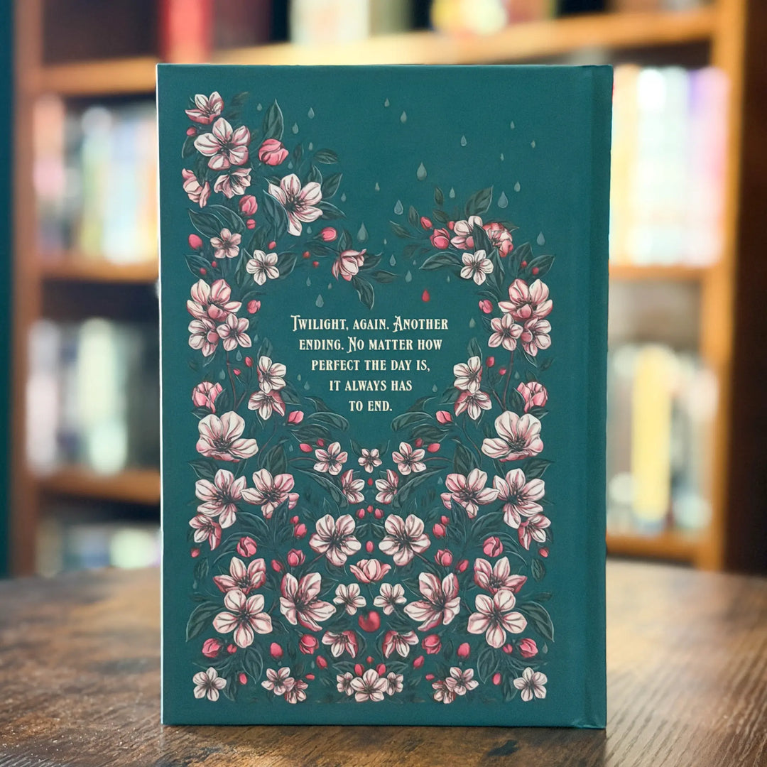 Book with floral design and text on a wooden surface