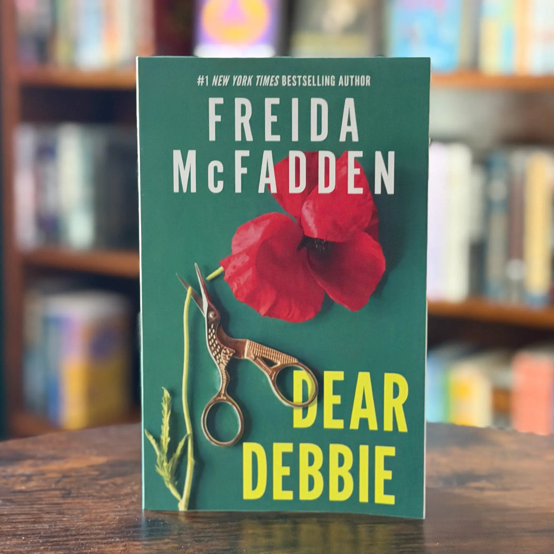 Book cover of 'Dear Debbie' by Freida McFadden with a red flower and scissors on a green background.