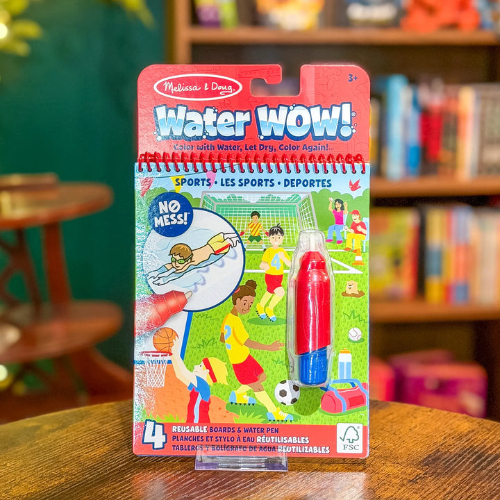 Melissa &amp; Doug Water WOW! Sports coloring book and pen set on a wooden table with a blurred background.