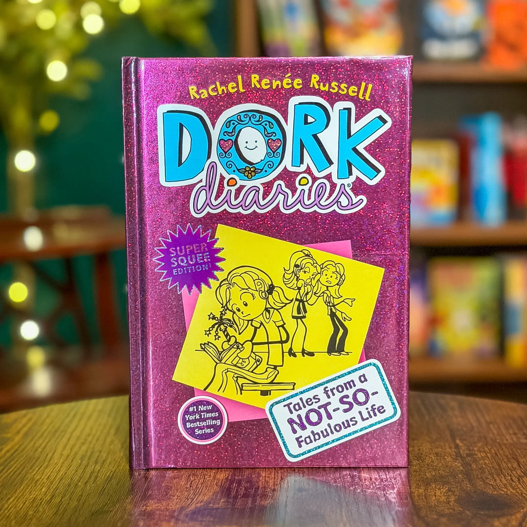 Book titled 'Dork Diaries' by Rachel Renée Russell on a wooden surface with a blurred bookshelf background.