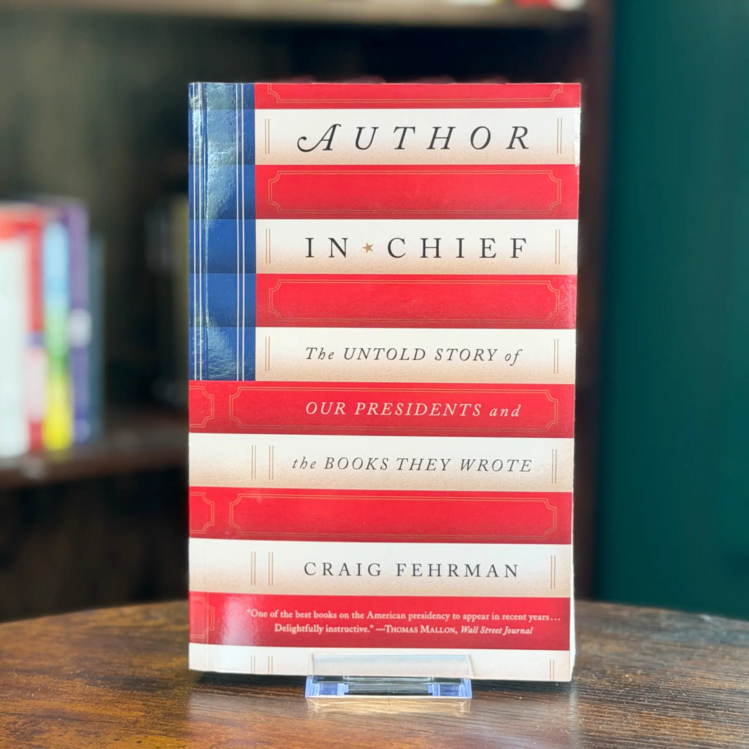 Book titled 'Author in Chief' by Craig Fehrman on a wooden surface with a blurred background