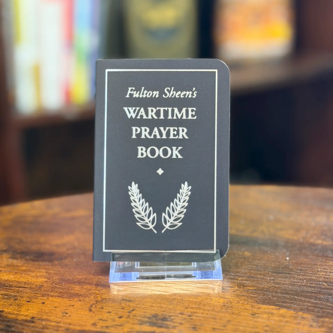Fulton Sheen's Wartime Prayer Book on a stand with a blurred bookshelf background