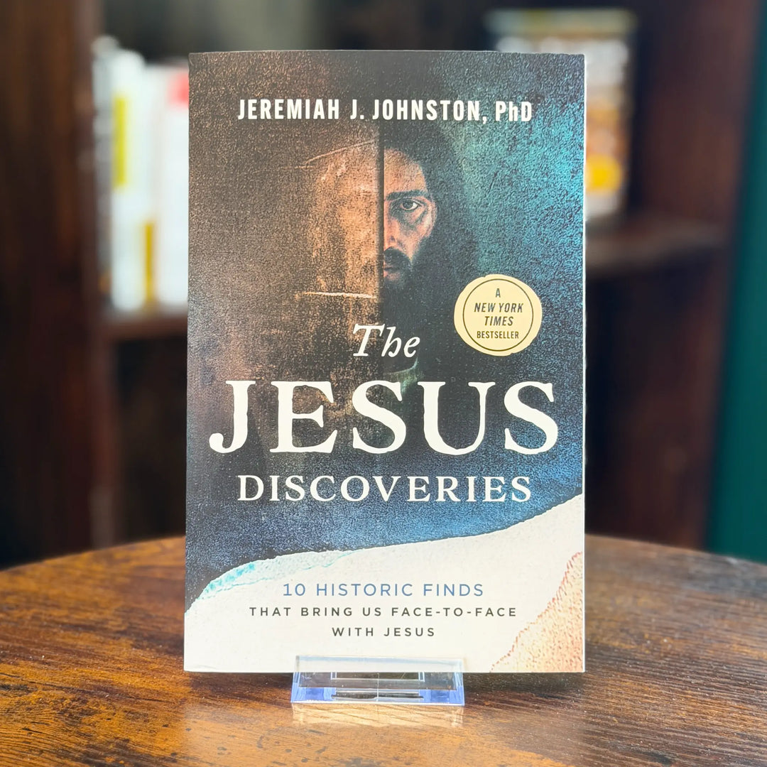 Book titled 'The Jesus Discoveries' by Jeremiah J. Johnston, PhD on a wooden surface.