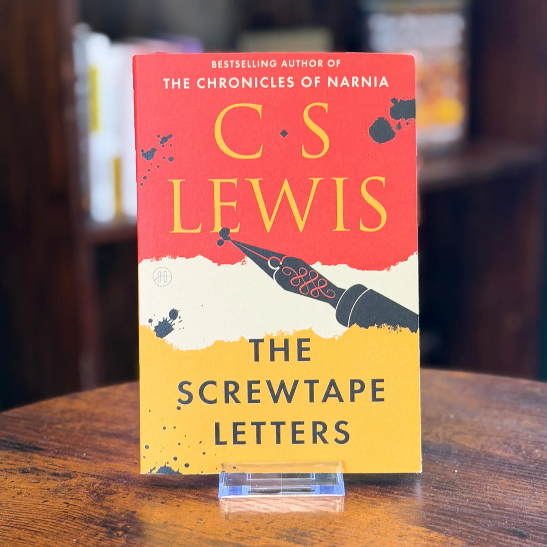 Book titled 'The Screwtape Letters' by C.S. Lewis on a wooden surface with a blurred background.