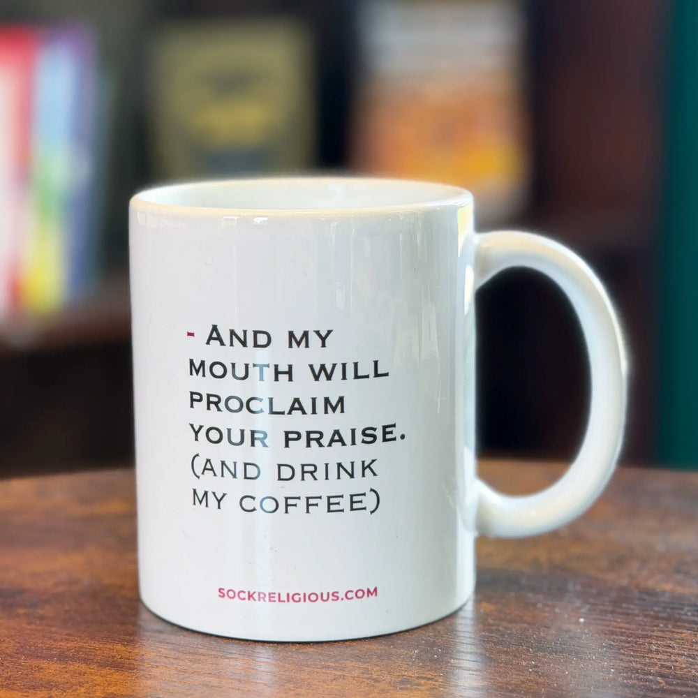 White mug with text on a wooden surface
