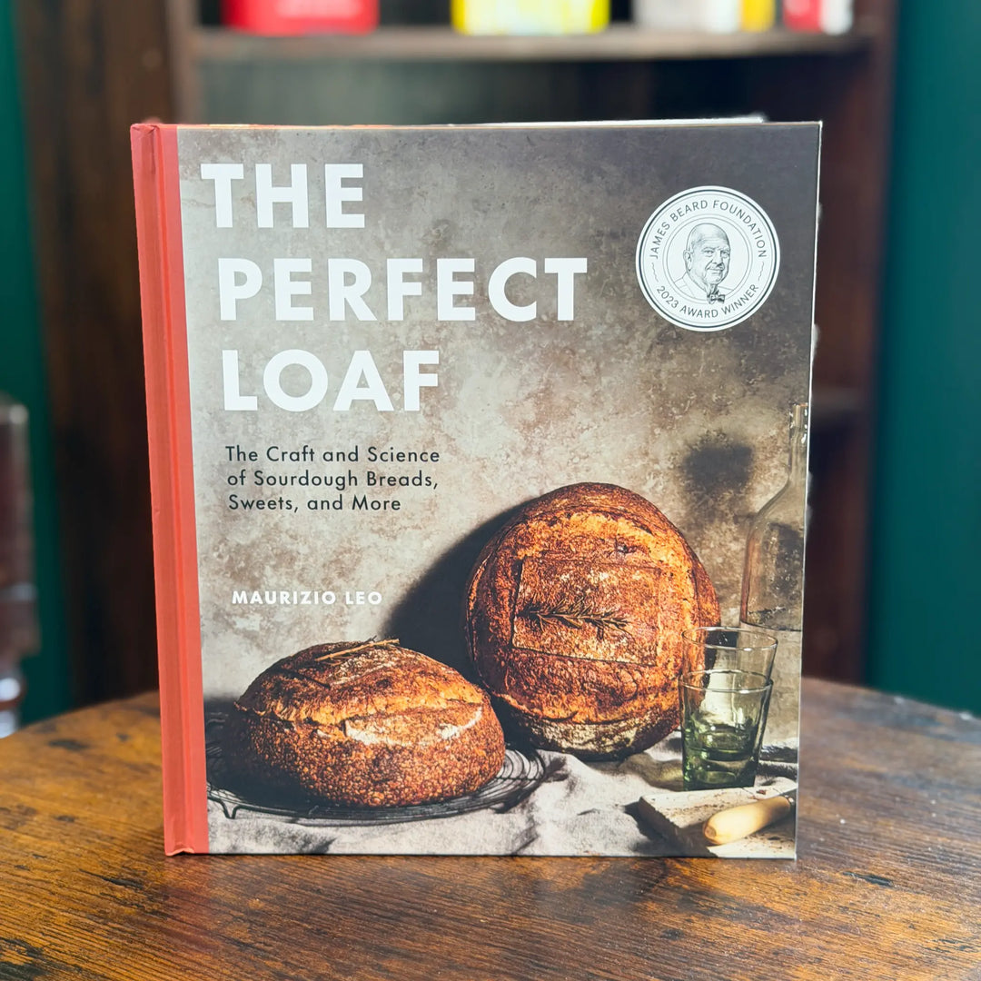Book titled 'The Perfect Loaf' on a wooden table