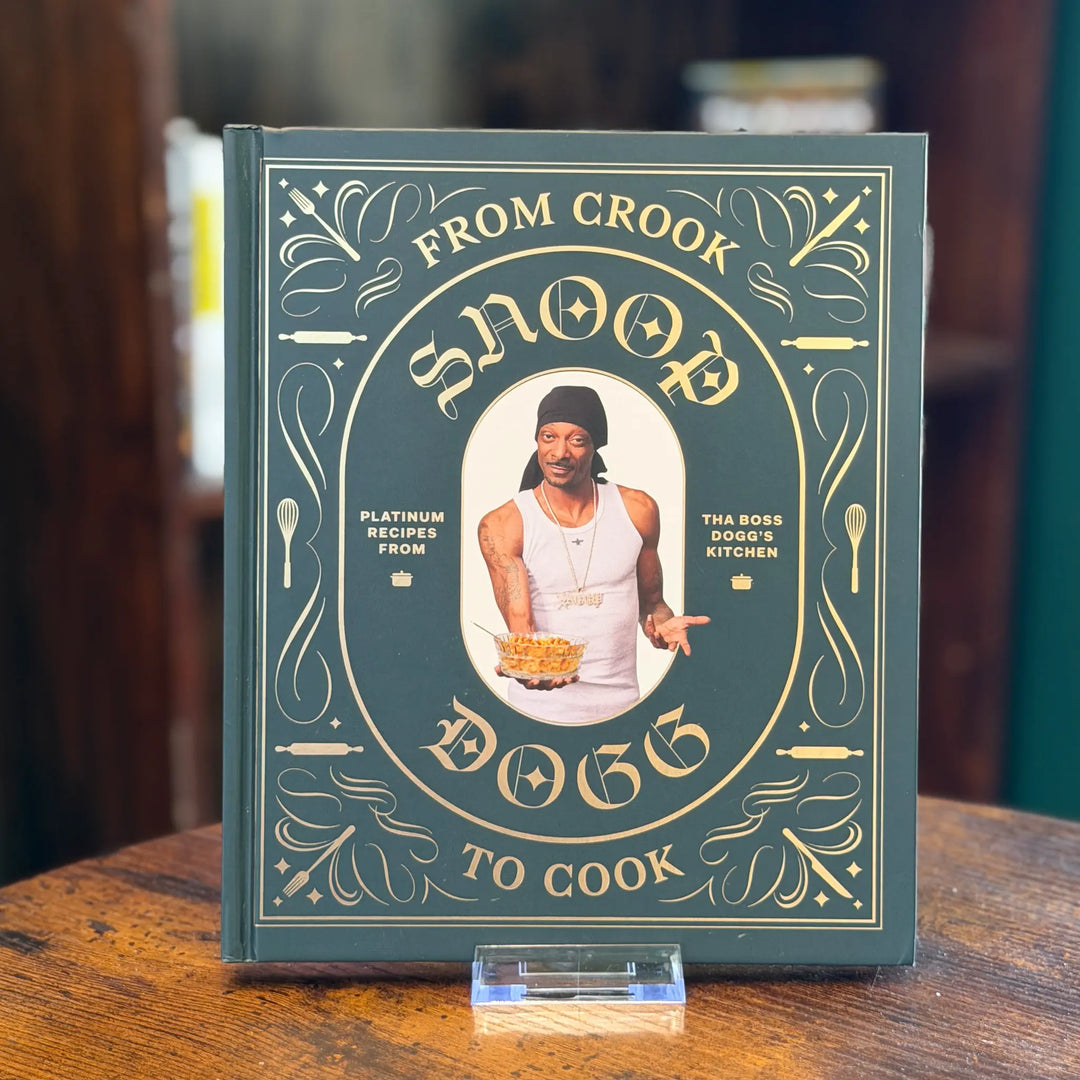 Cookbook titled 'From Crook to Cook' on a wooden surface