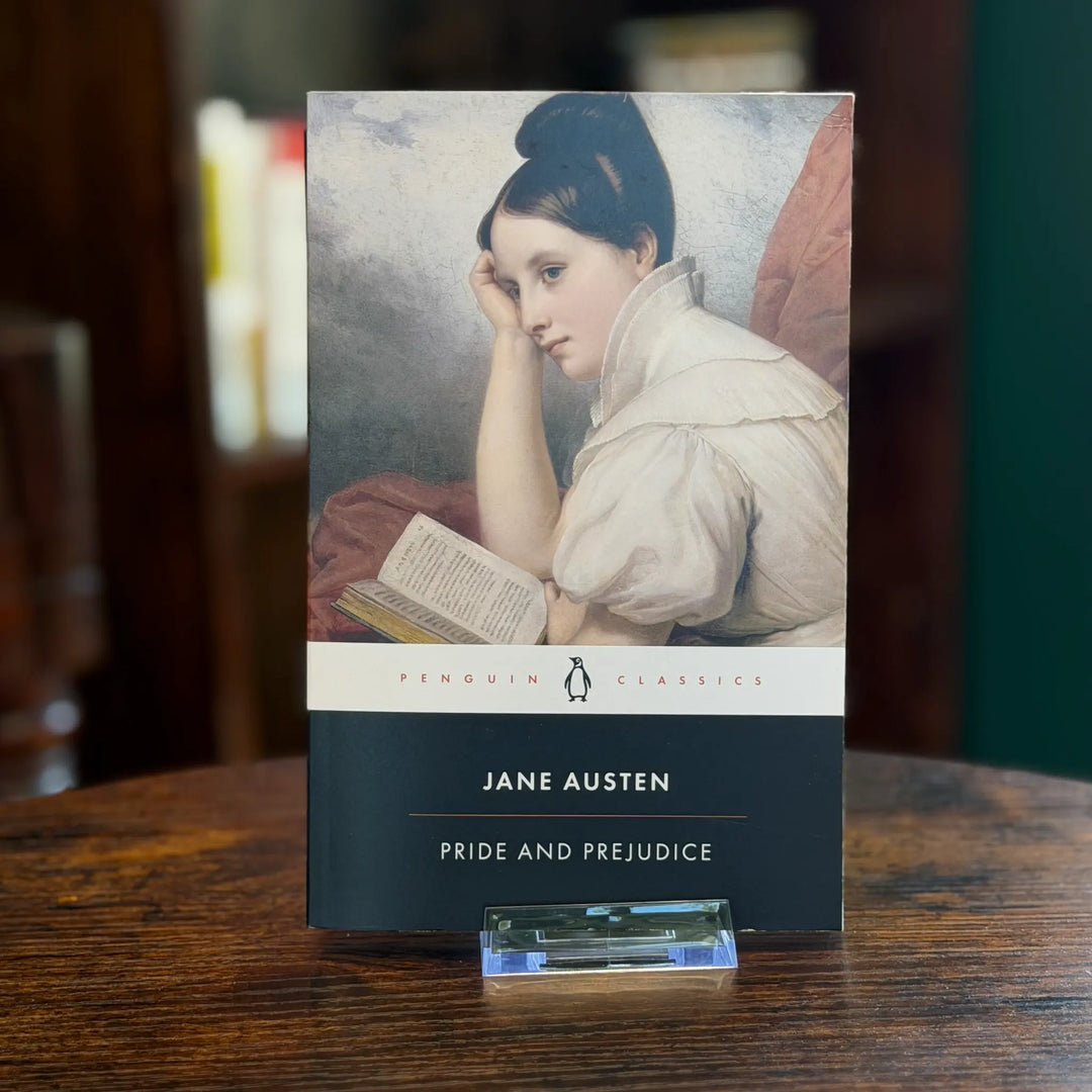 Book titled 'Pride and Prejudice' by Jane Austen on a wooden surface