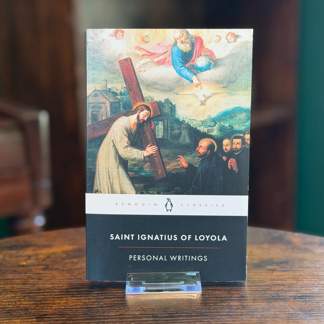 Book titled 'Saint Ignatius of Loyola: Personal Writings' by Penguin Classics on a wooden surface.