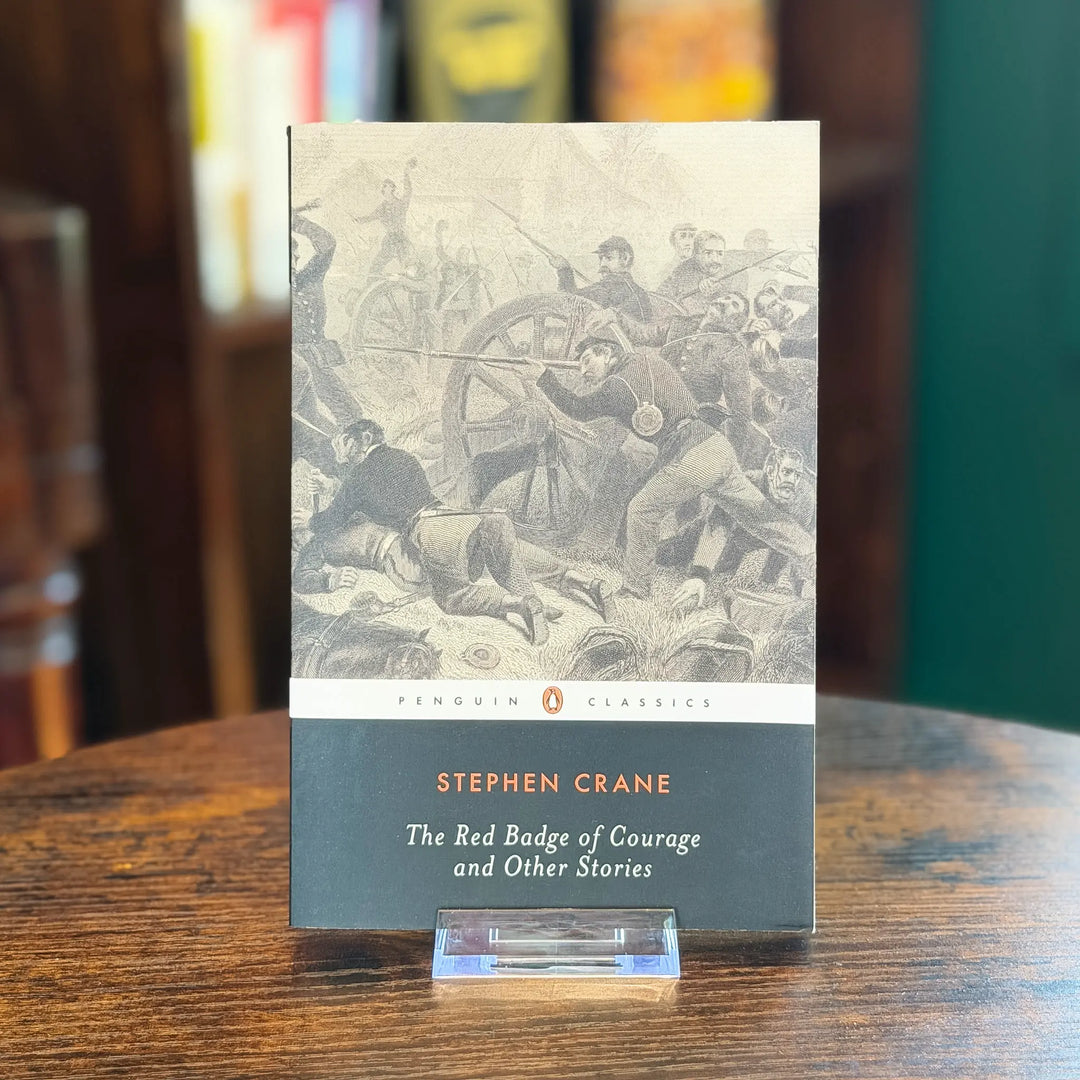 Book titled 'The Red Badge of Courage and Other Stories' by Stephen Crane on a wooden surface.