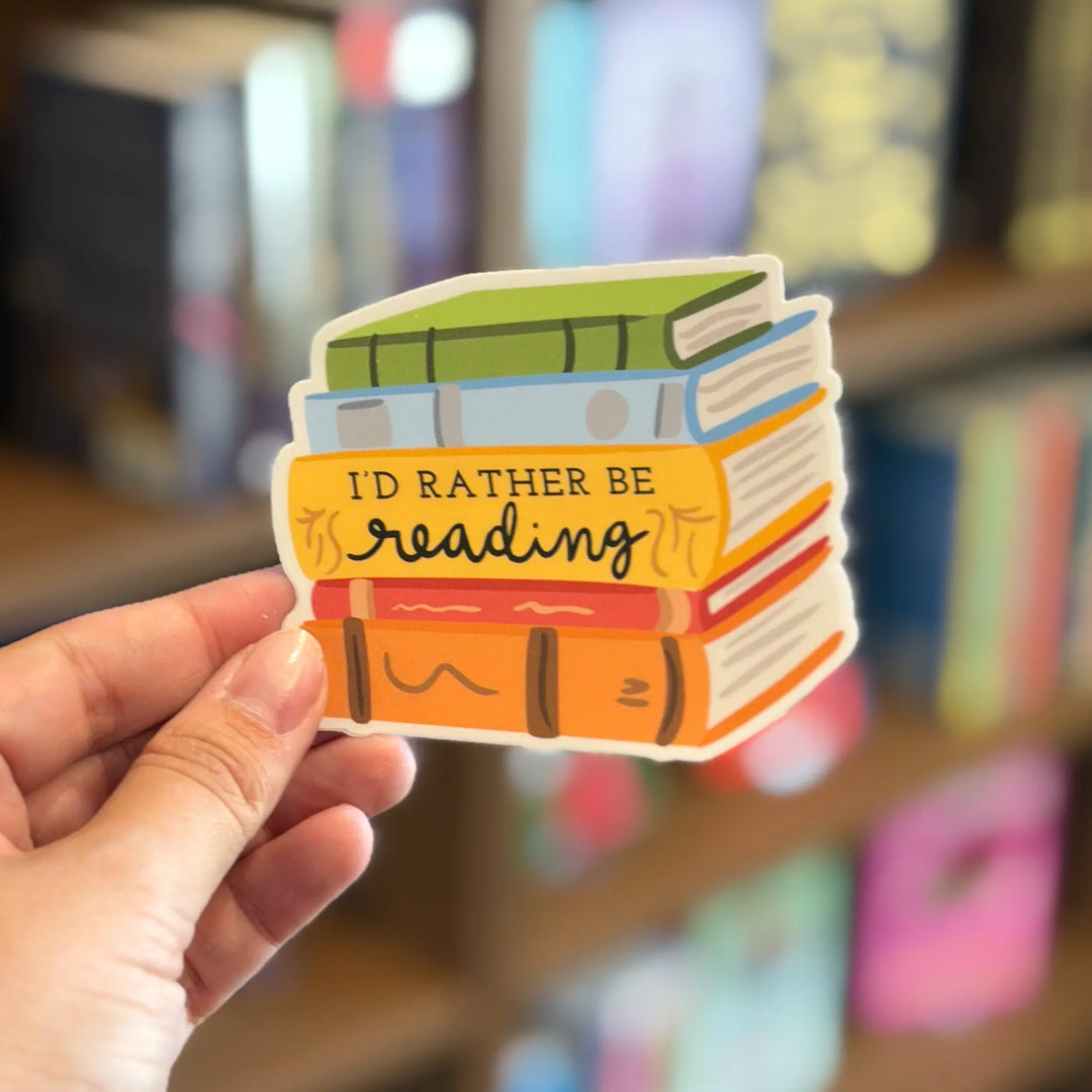 Hand holding a sticker with books and &