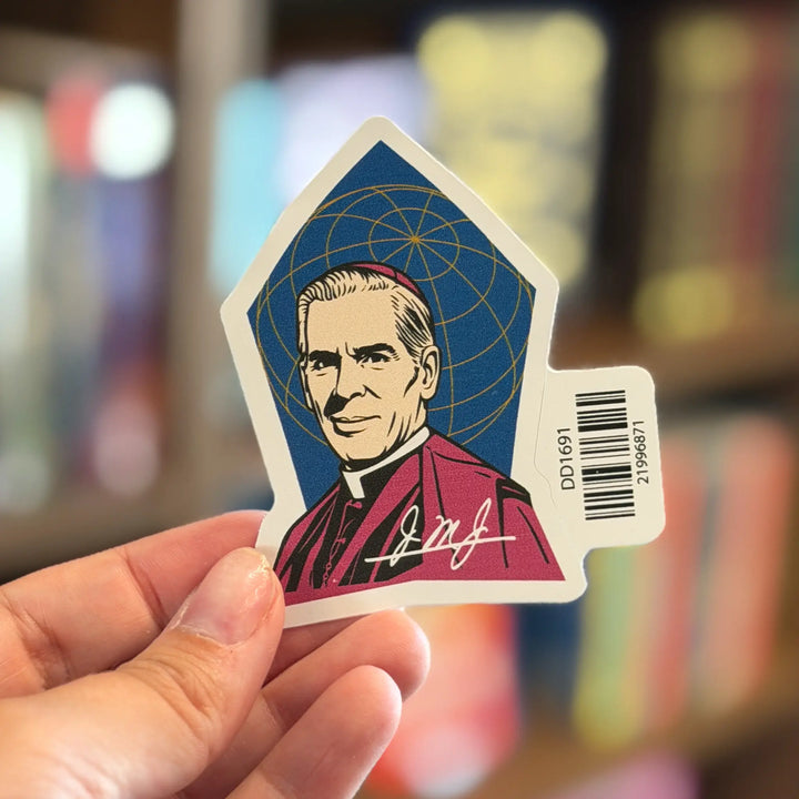 Sticker with a portrait and signature held by a hand against a blurred background
