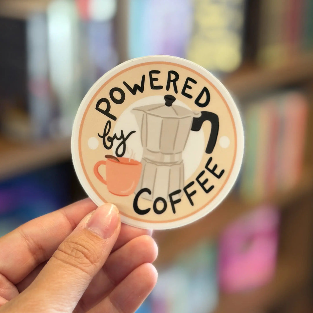 Circular sticker with a coffee pot and mug design, featuring the text &