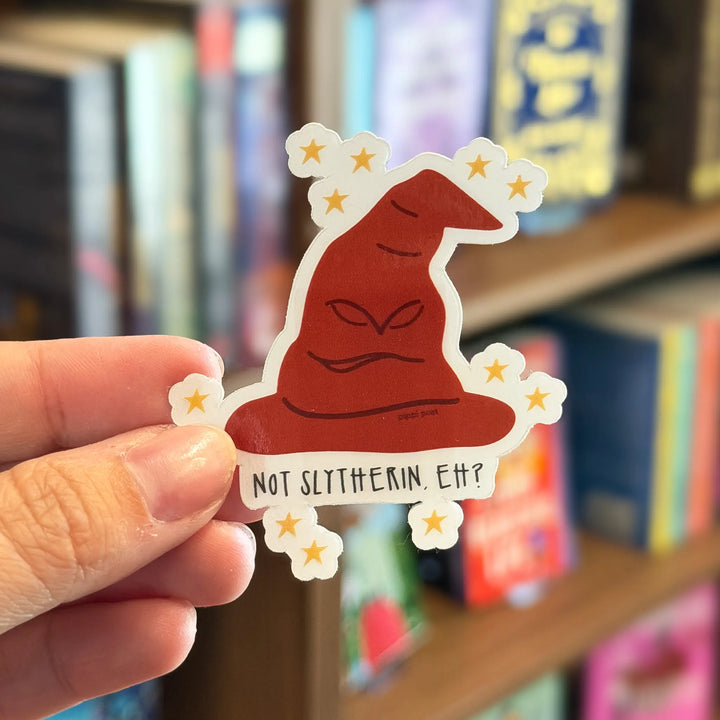 Hand holding a sticker with a Sorting Hat design and text &