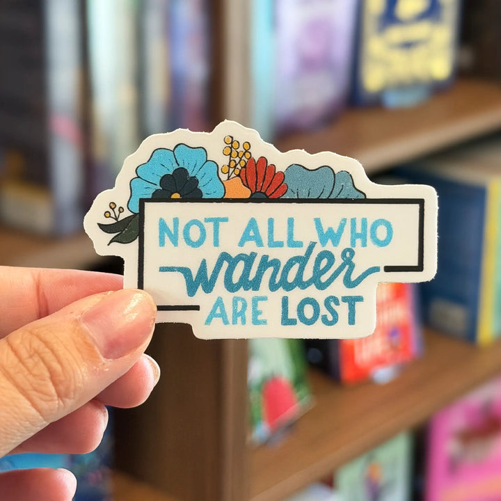 Hand holding a sticker with &