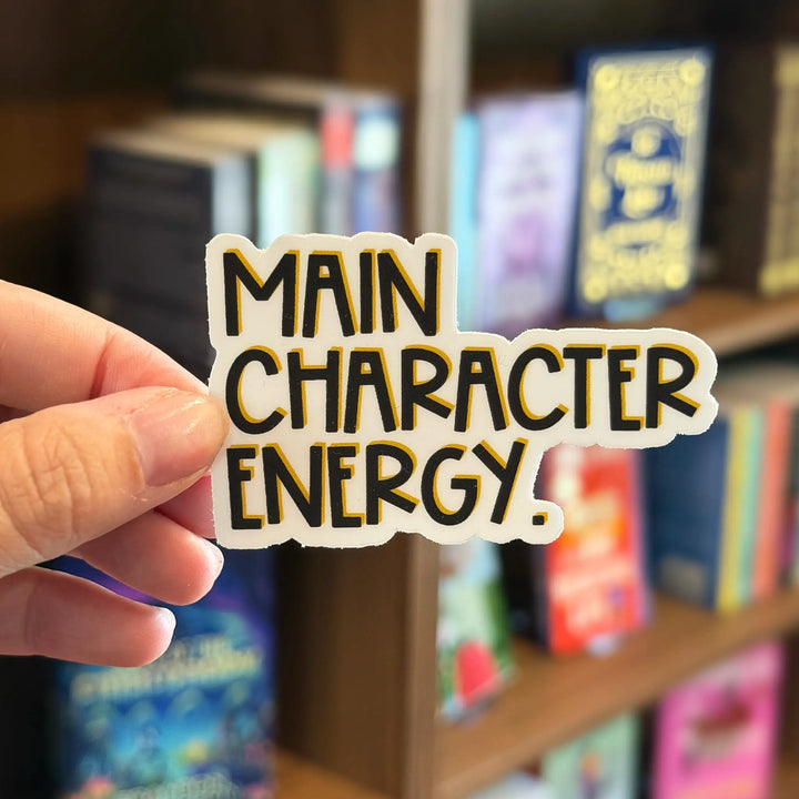 Hand holding a sticker with &