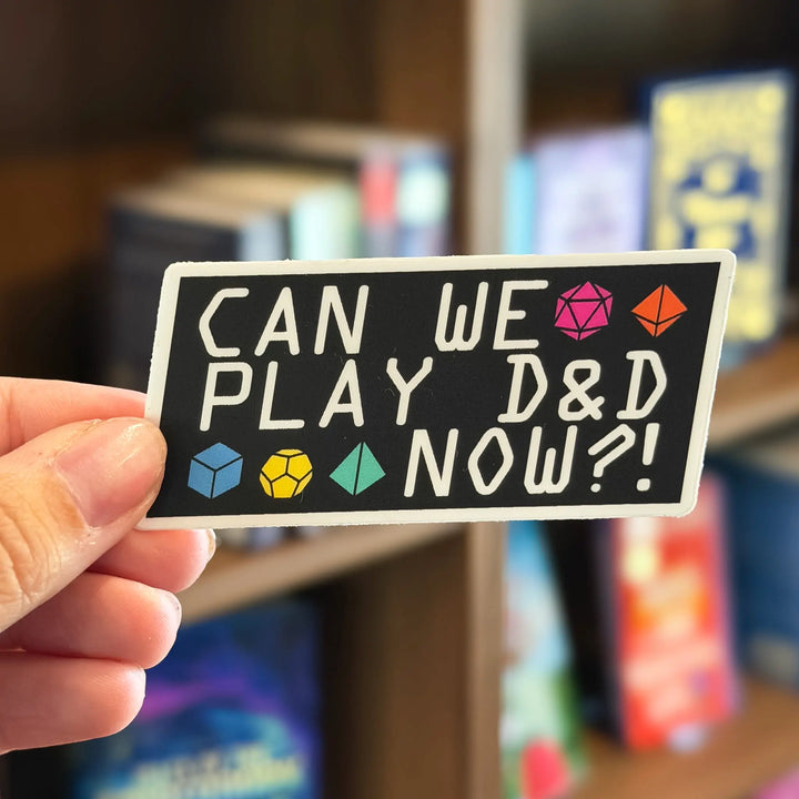 Hand holding a sticker with &