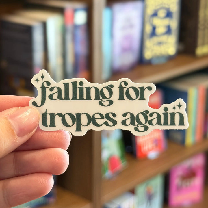 Hand holding a sticker with &
