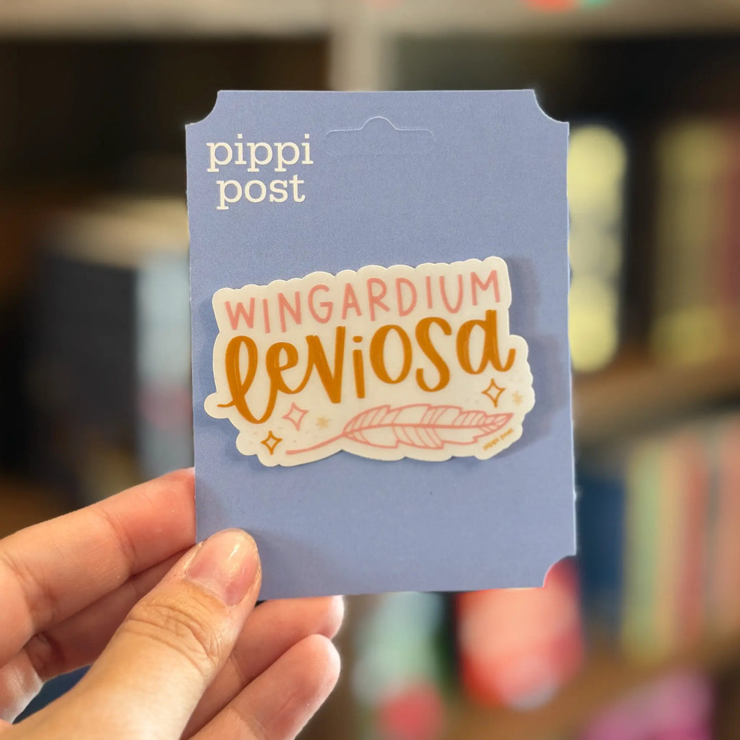 Sticker with 'Wingardium Leviosa' text on a blue card held by a hand, with 'pippi post' branding.