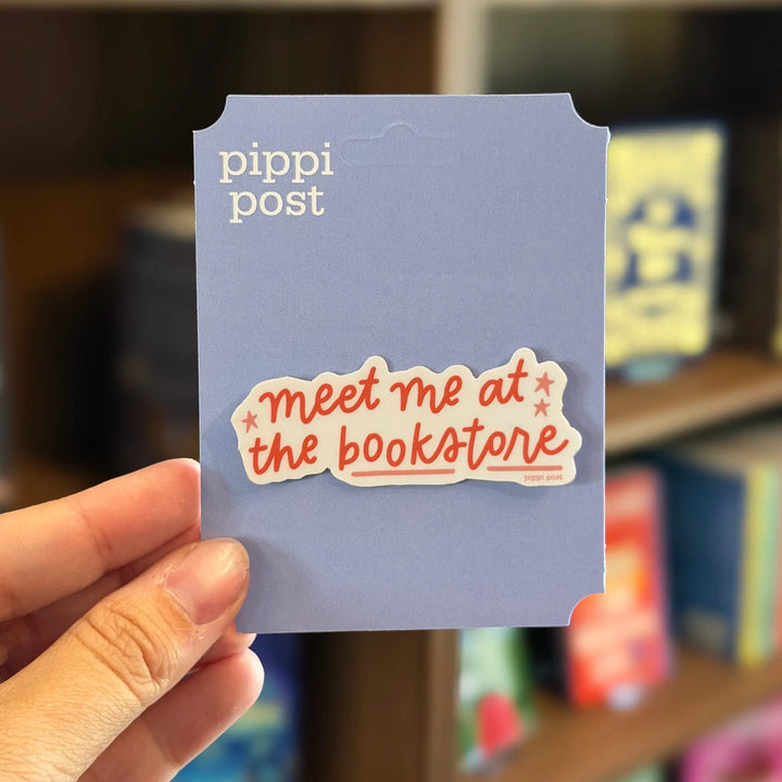 Hand holding a sticker with &