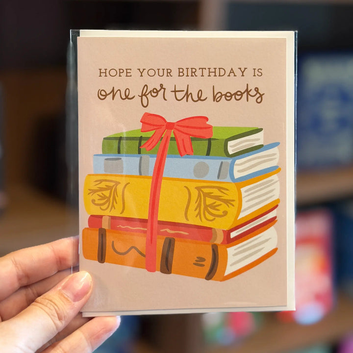 Greeting card with books and a bow, text &