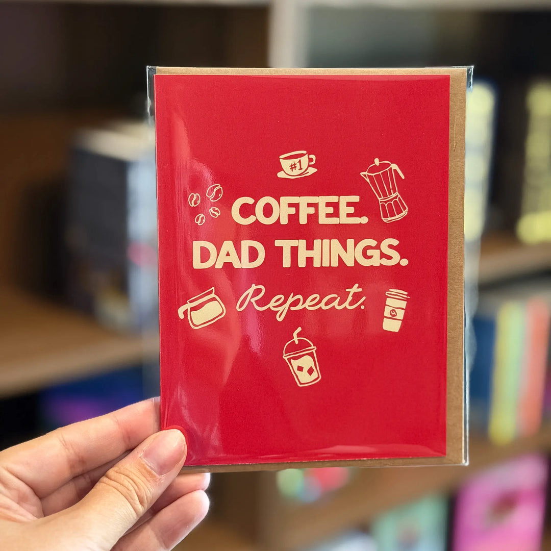 Red card with 'Coffee. Dad Things. Repeat.' text and coffee-themed icons held by a hand.