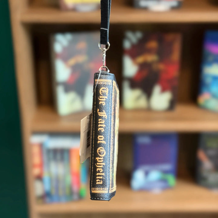 Book-shaped wallet with a blurred bookshelf background