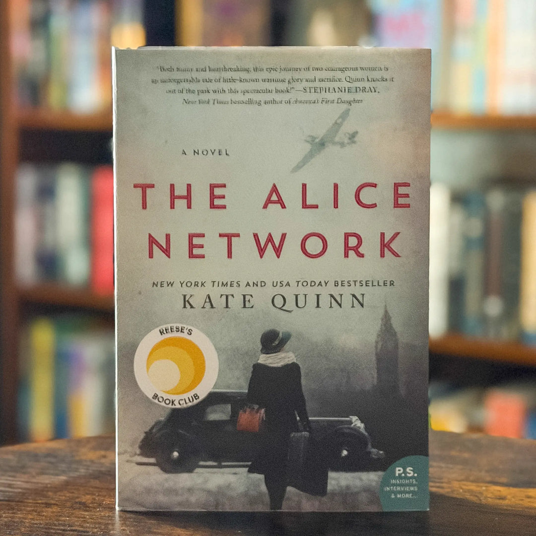 Book titled 'The Alice Network' by Kate Quinn on a wooden surface with a blurred bookshelf background.