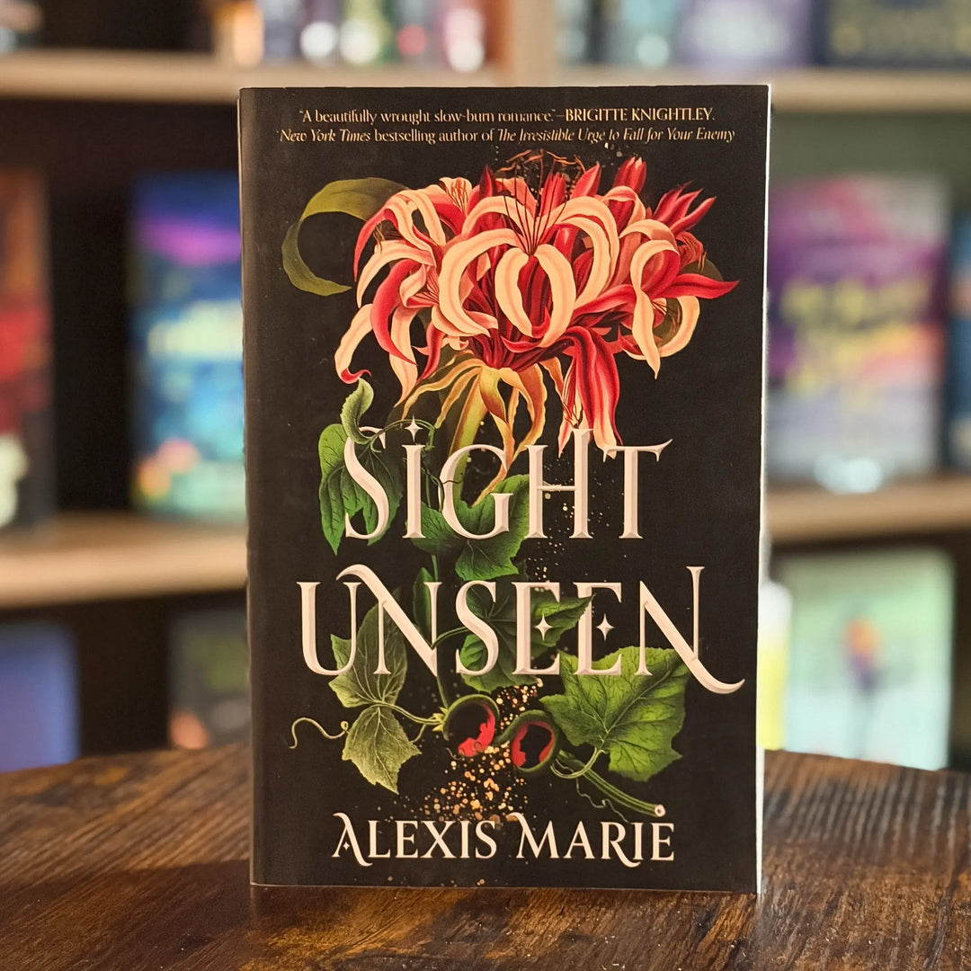 Book titled 'Sight Unseen' by Alexis Marie on a wooden surface with a blurred bookshelf background.