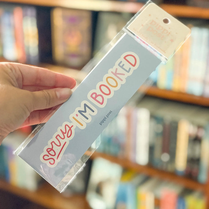 Hand holding a bookplate with &