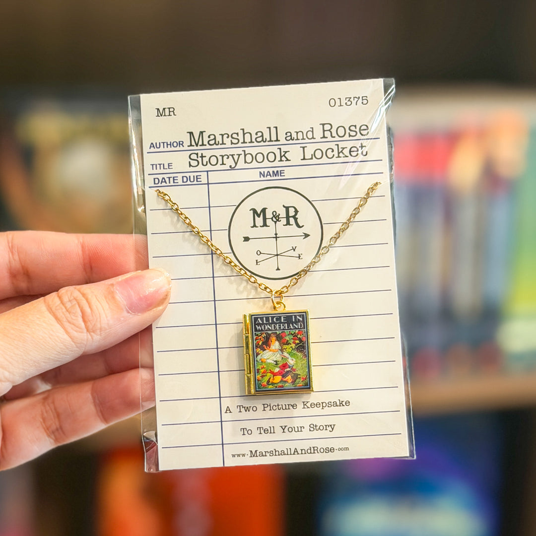 Gold necklace with 'Alice in Wonderland' book pendant on a library card background