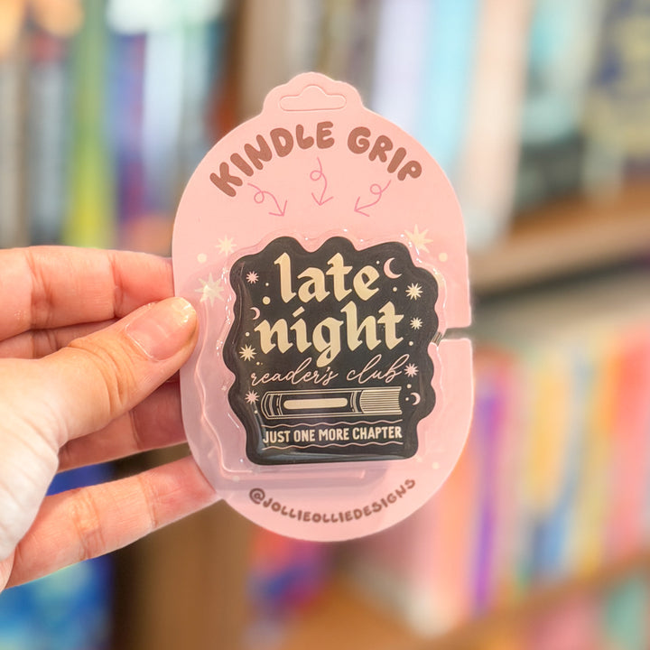 A hand holding a pink carded pin that reads &