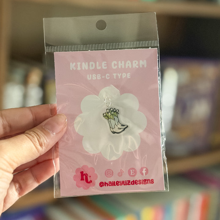 A hand holding a clear plastic bag containing a pink card labeled &