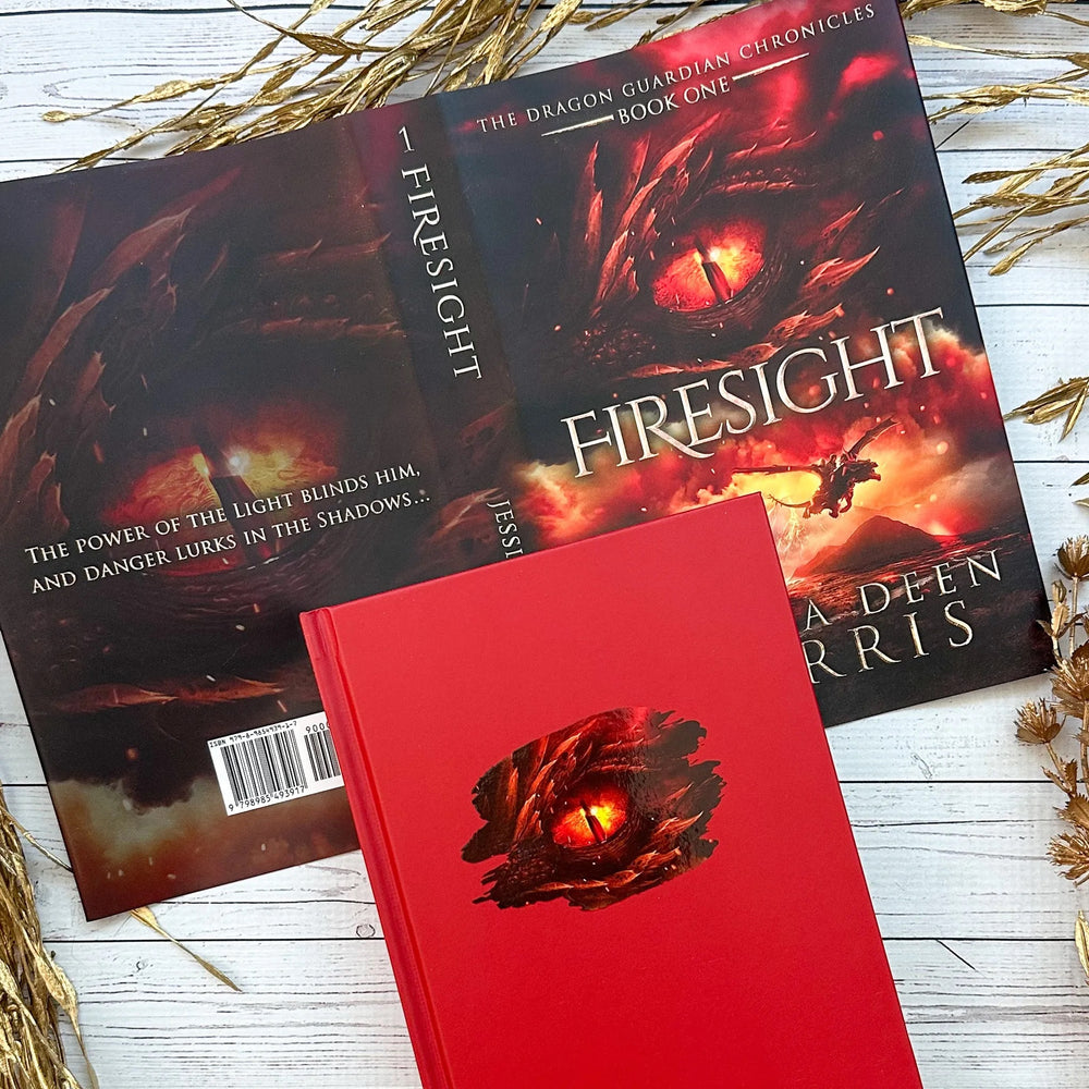 Book titled 'Firesight' from 'The Dragon Guardian Chronicles' on a wooden surface with decorative elements.
