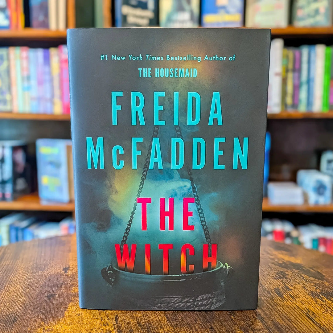 Book cover of 'The Witch' by Freida McFadden with a dark background and colorful text.