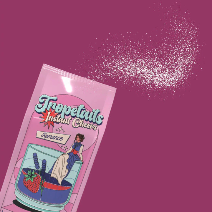 Pink packaging of Tropetails Instant Cheers on a purple background
