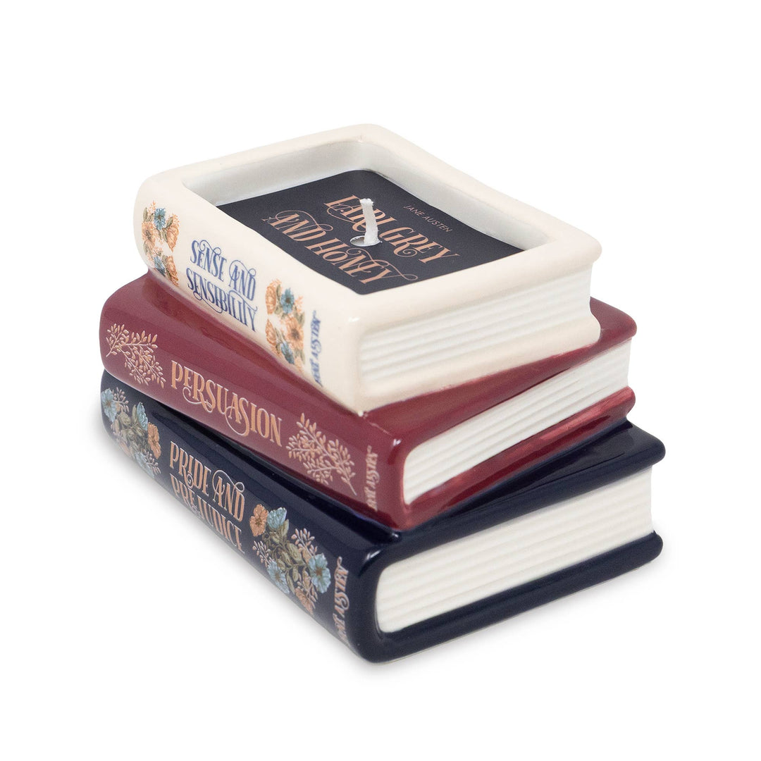 Angled view of Jane Austen bookstack candle showing floral spines, sculpted pages, and Earl Grey and Honey label.