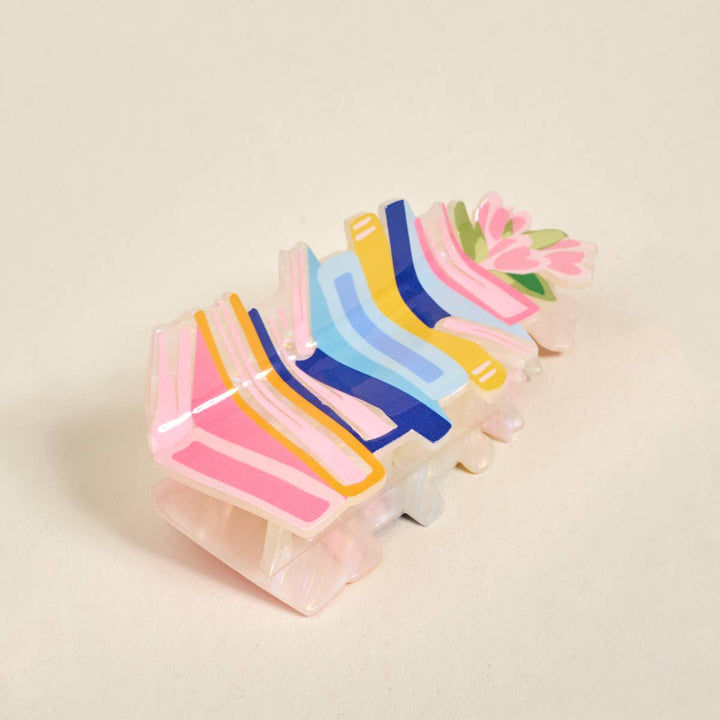 Colorful plastic clip on a beige background