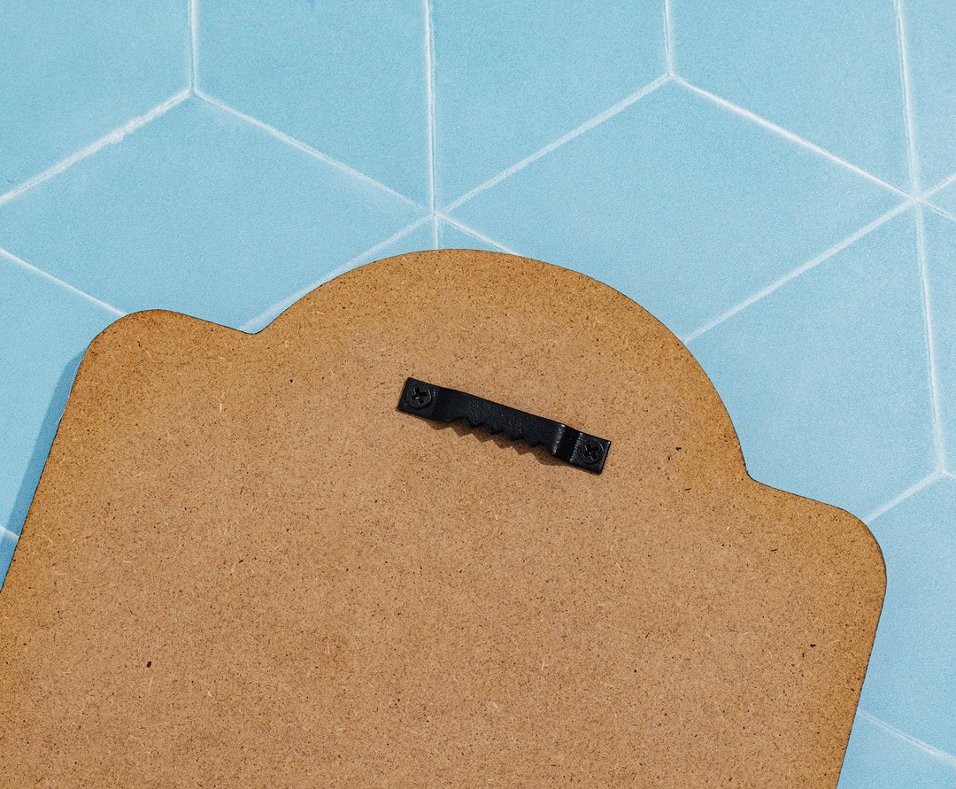 Brown cardboard with a black strip on a blue tiled background