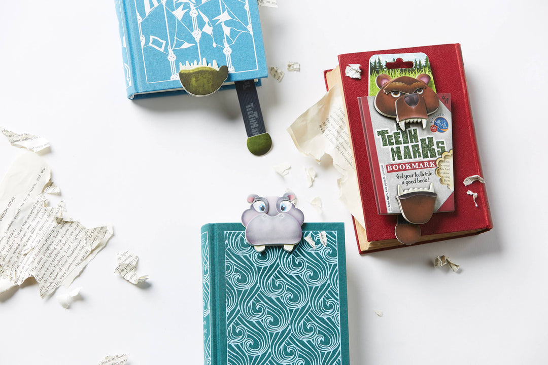 Two bookmarks with cartoon characters on a white surface