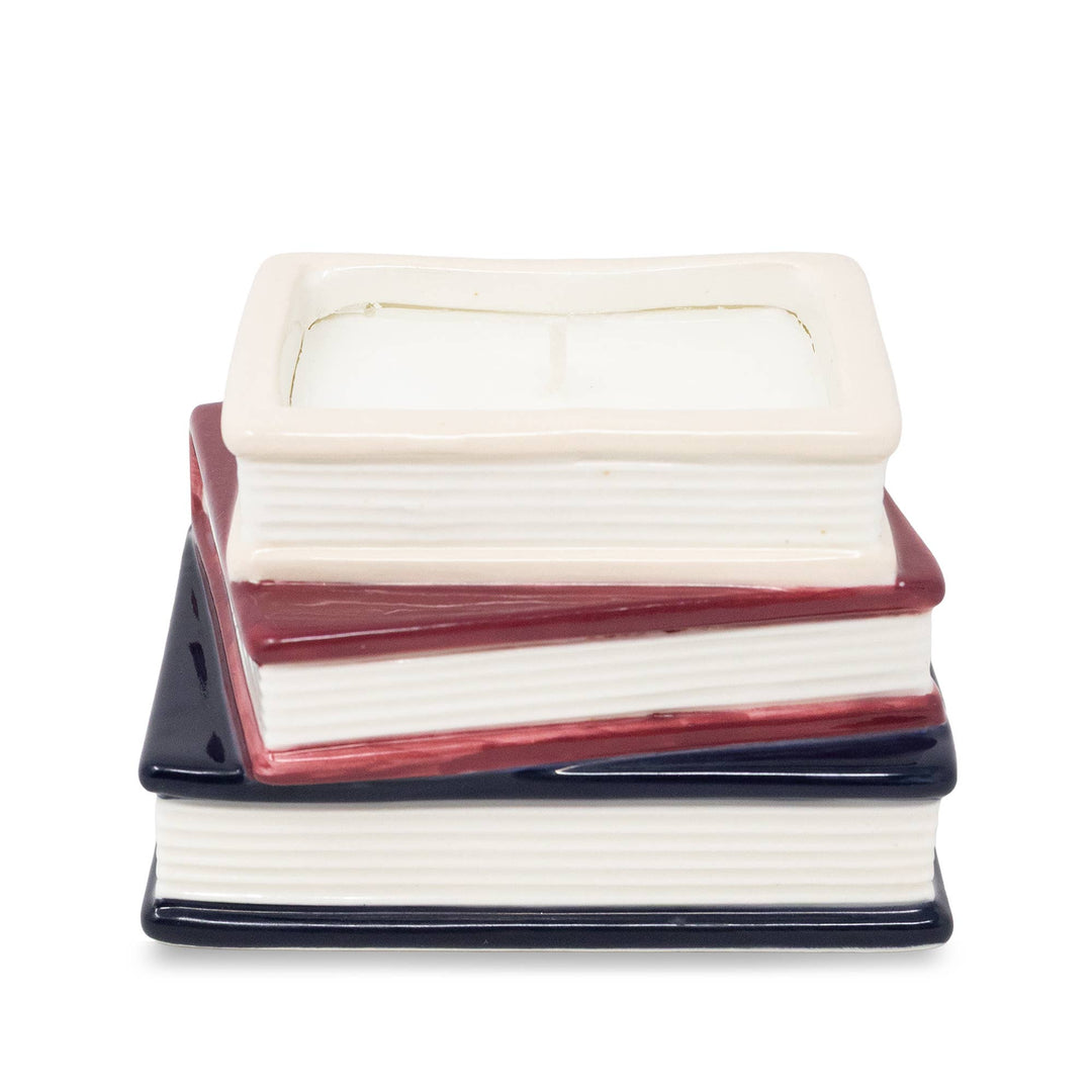 Back view of Jane Austen bookstack candle showing sculpted white page edges and cream, burgundy, and navy covers.