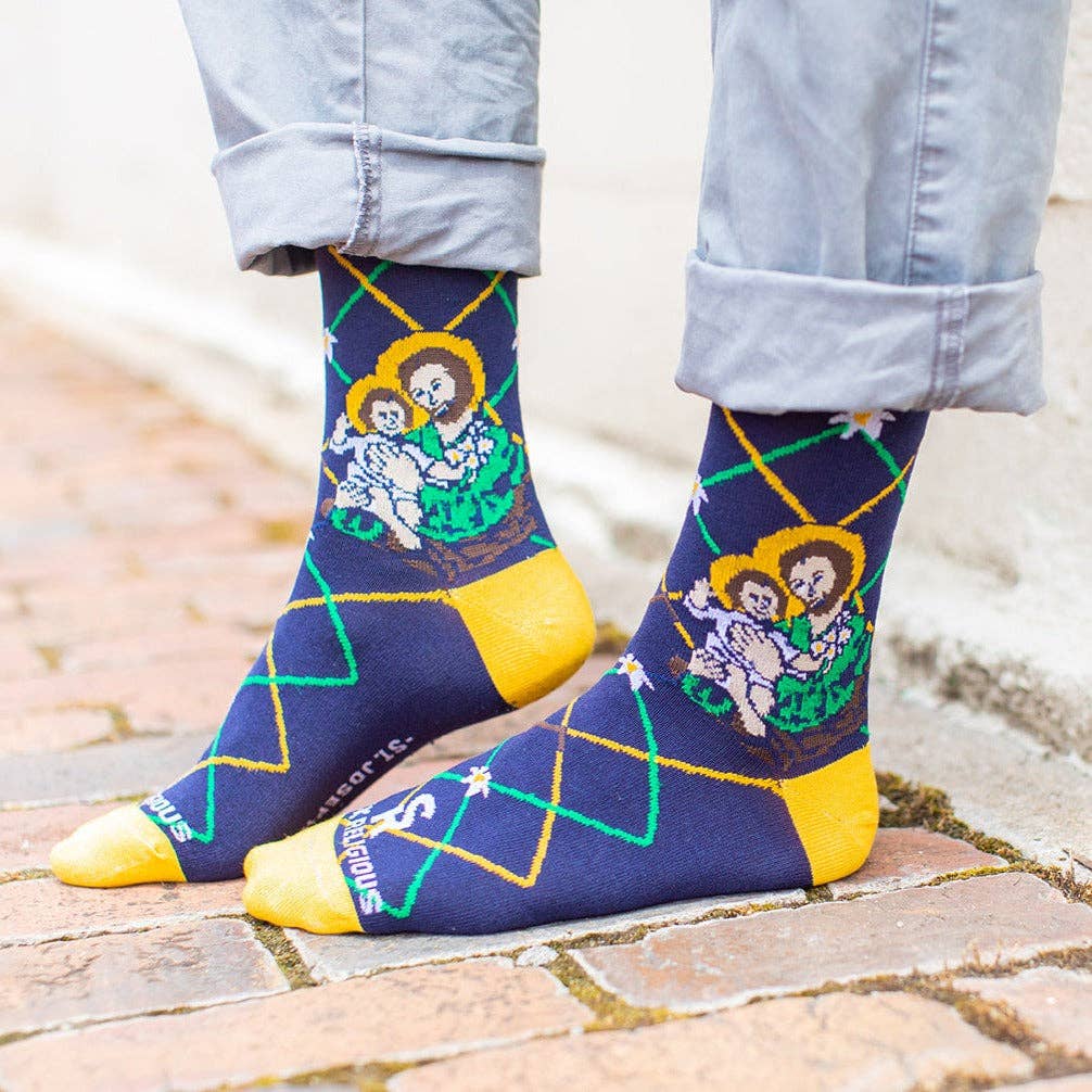 Person wearing socks with artistic designs on a stone pavement