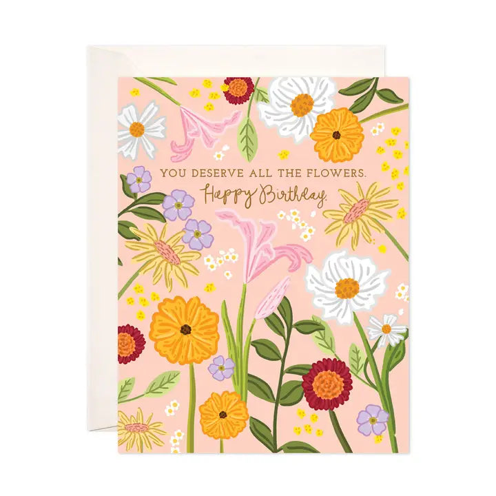 Floral birthday card with colorful flowers on a pink background. Text reads &