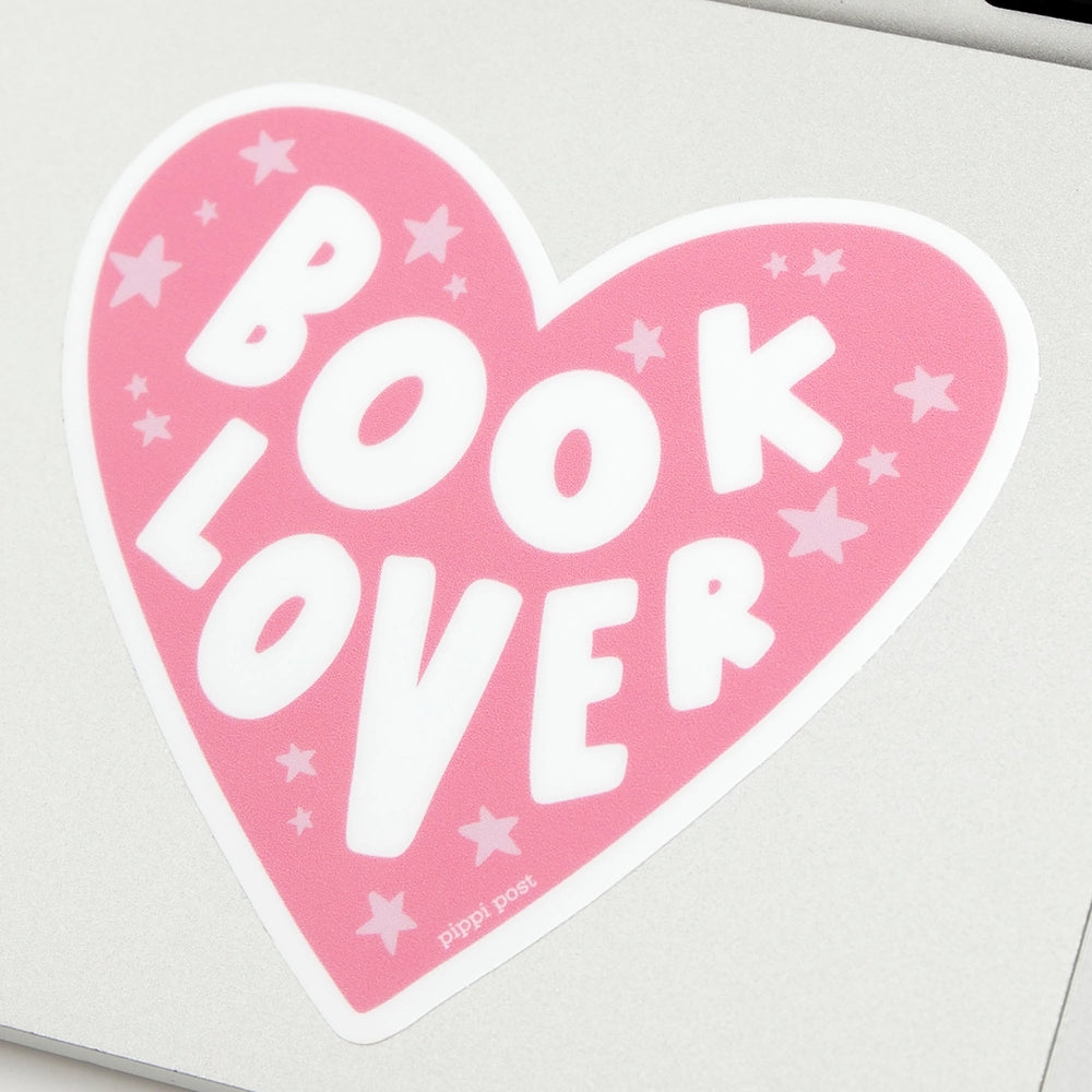Pink heart-shaped sticker with 'Book Lover' text on a light gray background