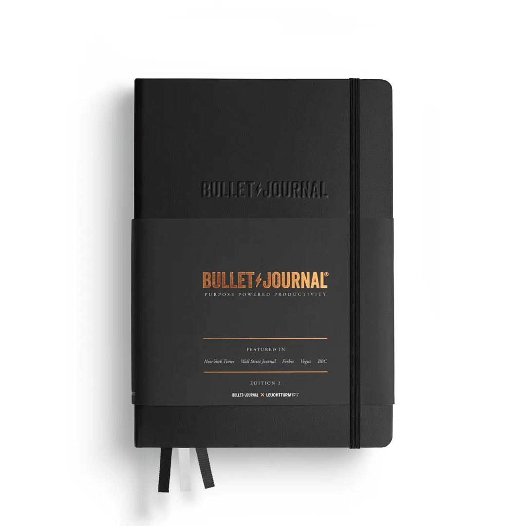 Black Bullet Journal notebook with branding on a white background