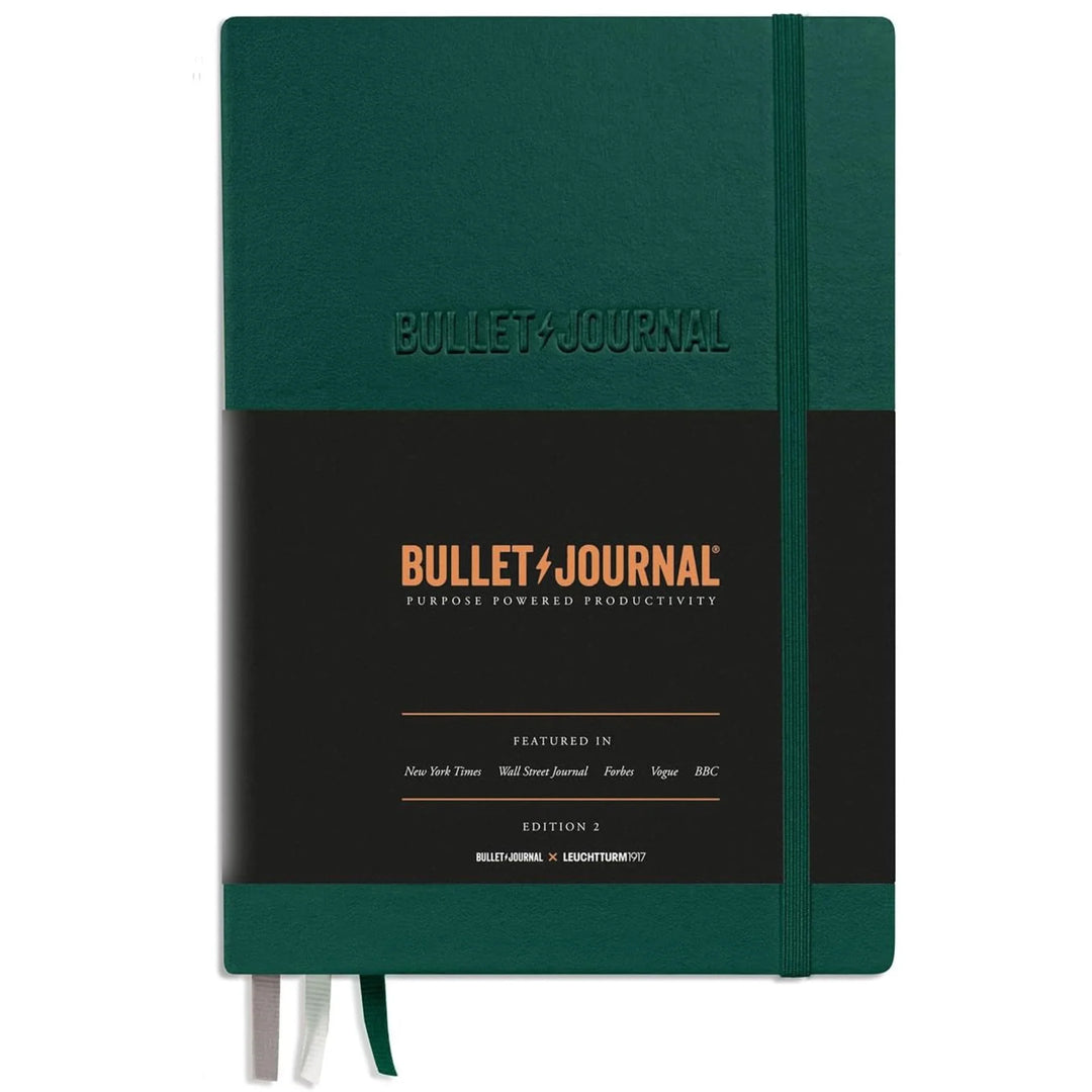 Green notebook with 'Bullet Journal' branding on a white background